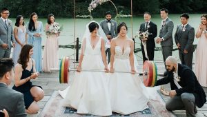 Brides deadlift together at wedding