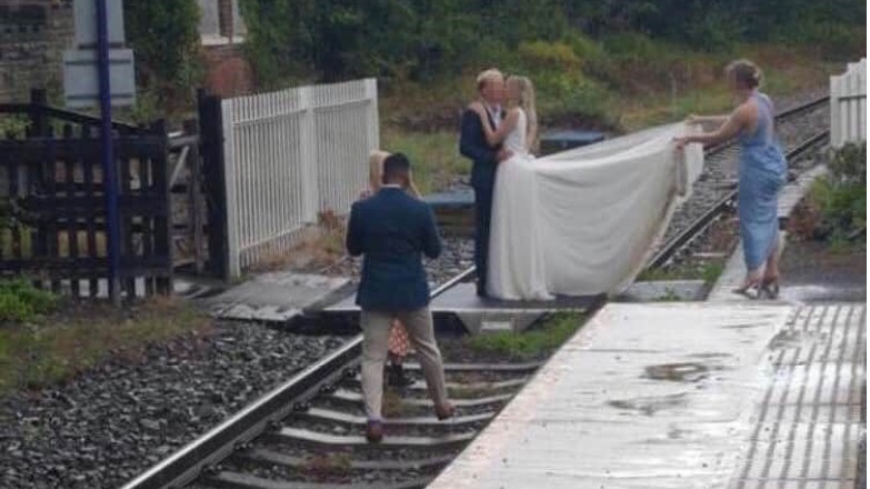 Newlyweds under fire for posing on train tracks