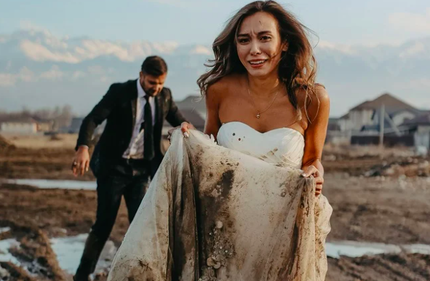You had one job! Groom drops bride in mud during wedding photoshoot